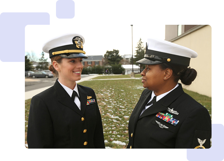 Two women in military uniforms standing next to each other.