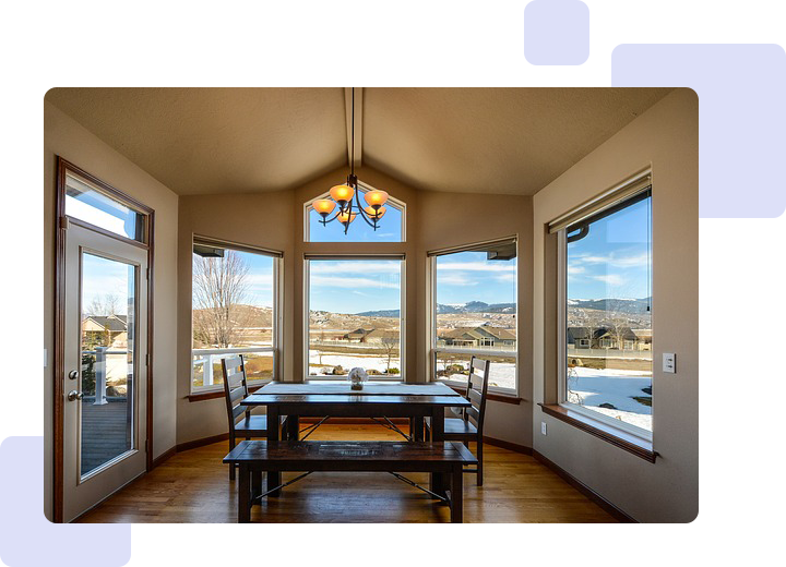 A dining room with a table and chairs in it