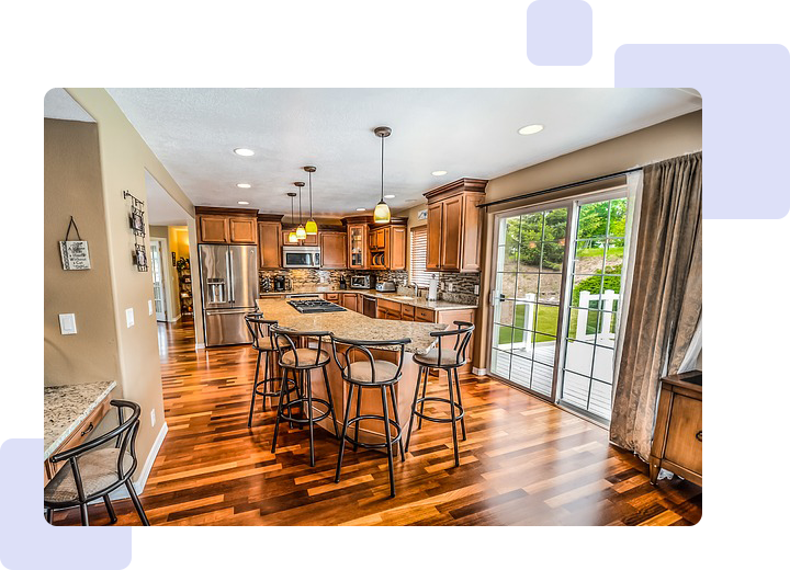 A kitchen with wooden floors and a large island.