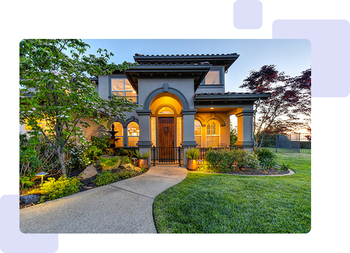 A house with a garden and lawn in front of it