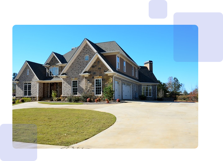 A large house with a driveway and lawn.